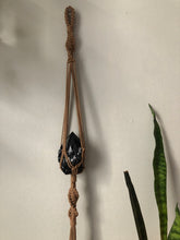 Load image into Gallery viewer, A brown spiral macrame hanger holding a black obsydian crystal.
